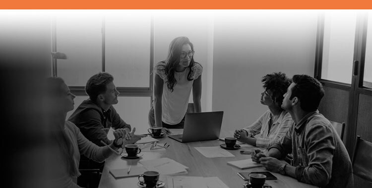 Boss talking to her employees with Interstaff orange top border for Permanent Work Visas service