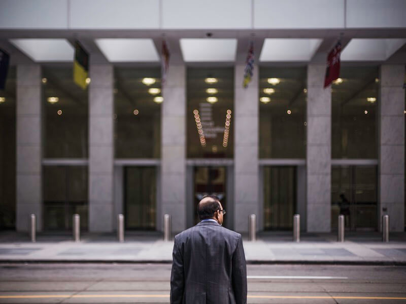 Man standing across from building
