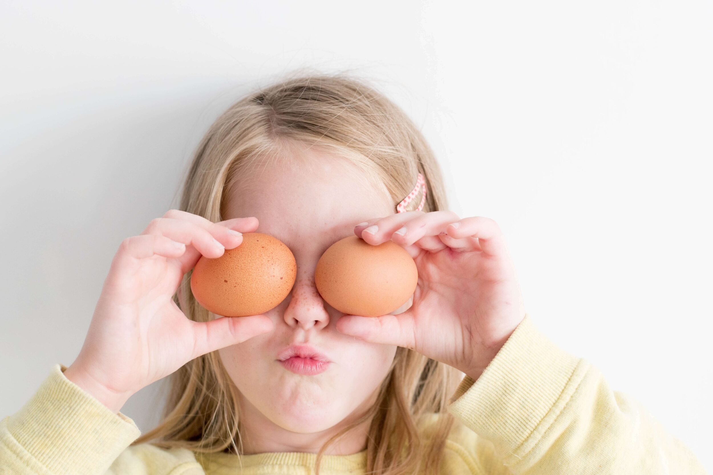 Young girl with two eggs over her eyes for Easter Perth celebrations