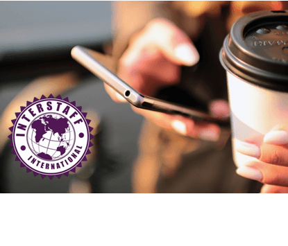 Woman holding her mobile phone and coffee cup with Interstaff International logo