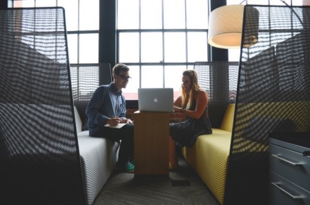 Man and woman working together in their open work space