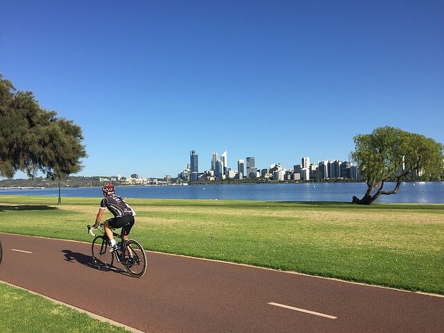 Man cycling in Perth, one of the top 10 most liveable cities