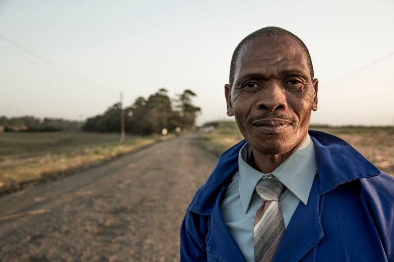 Closeup of ethnic man standing on road