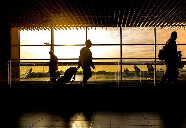 Silhouettes of individual who has traveled to Australia on motorised tract in airport. Australian immigration changes.