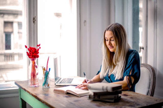 Woman at desk researching support for temporary visa holders in Australia